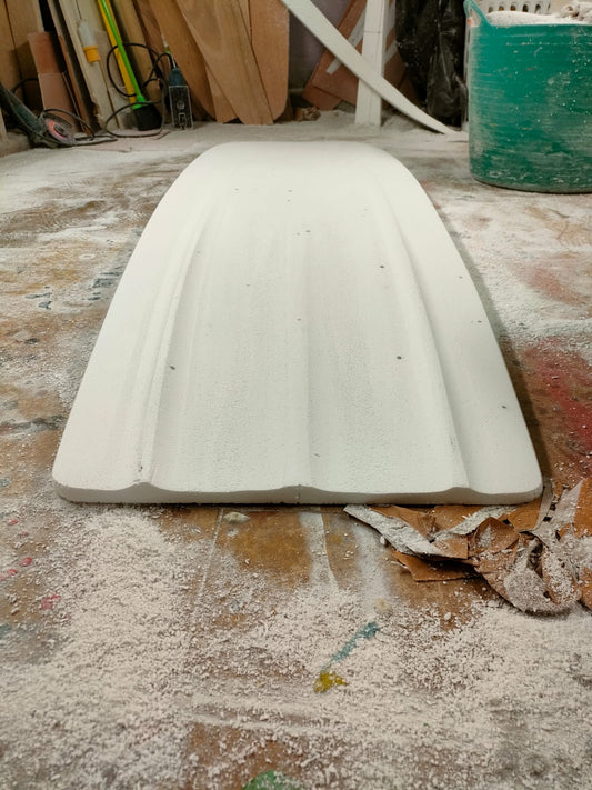 Bottom of a Booglerize surfboards white finless alaia style board shaped by Elvis Beetham