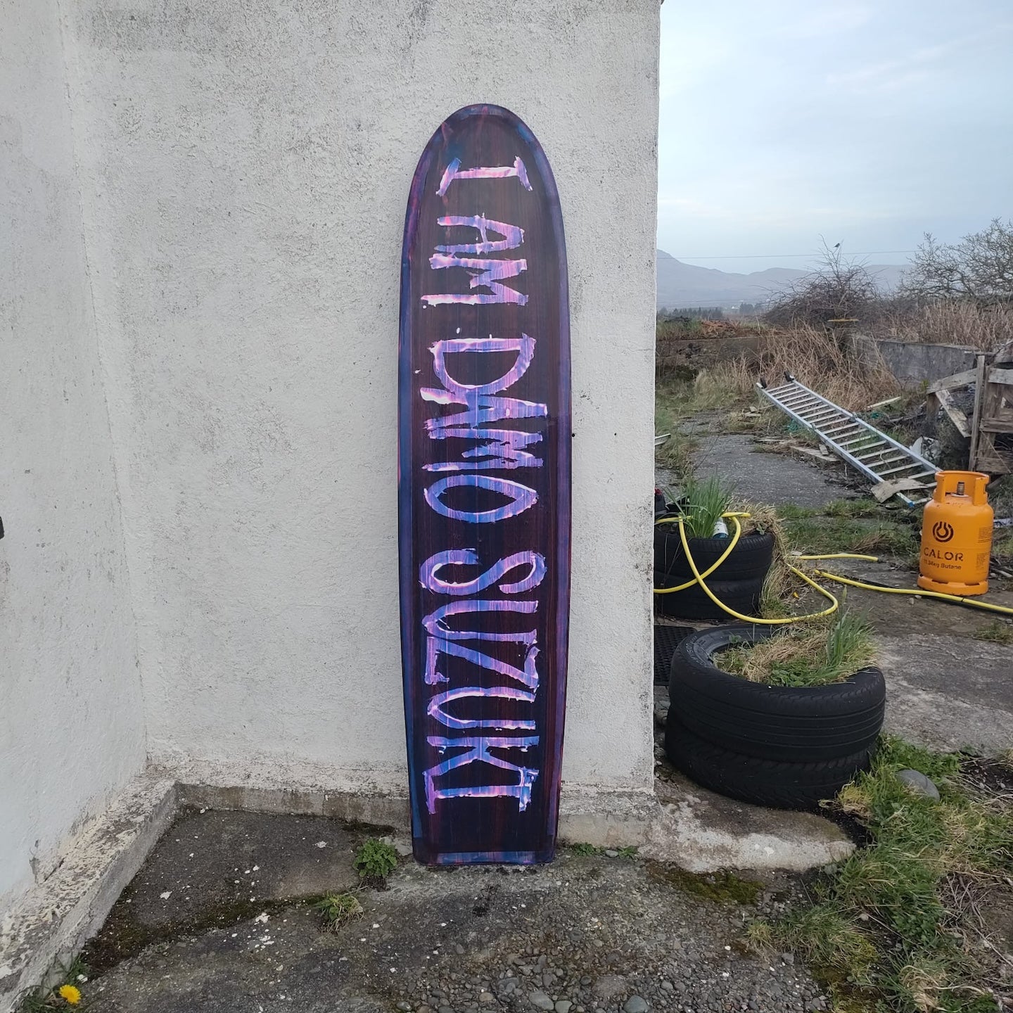 Bottom of a Booglerize surfboards purple and blue finless board shaped by Elvis Beetham